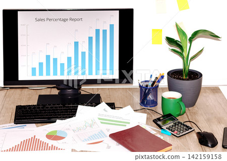 Businessman analyzing sales data on computer Businessman analyzing sales data on computer 142159158