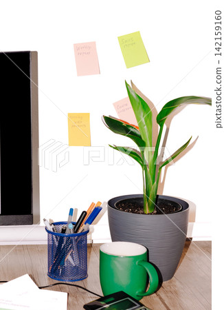 Workspace scene with plant, mug, and sticky notes 142159160