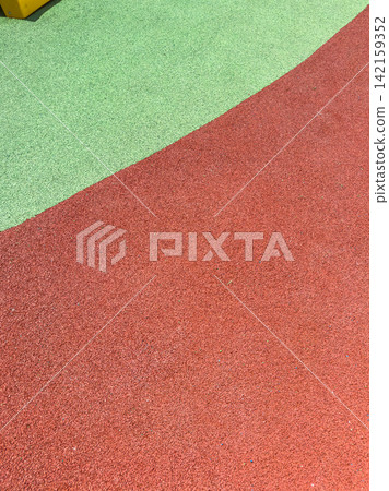 Colorful rubber surface at a playground with green and red areas showing Colorful rubber surface at a playground with green and red areas showing 142159352
