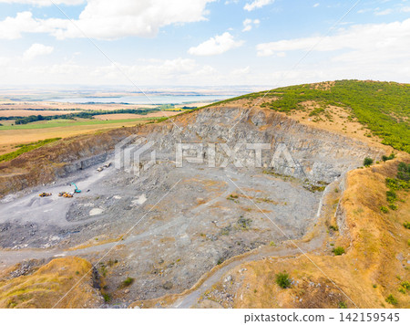 Granite quarry located in a rural area with heavy machinery and open space for stone extraction 142159545