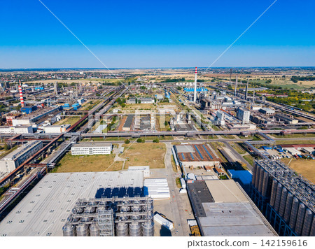 Urban industrial landscape with factories and warehouses on a clear day Urban industrial landscape with factories and warehouses on a clear day 142159616