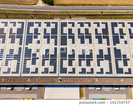 Large solar panel installation located on a rooftop in a rural area, showing a grid pattern during daylight hours Large solar panel installation located on a rooftop in a rural area, showing a grid pattern during daylight hours 142159747