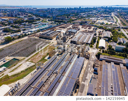 Factory area with solar panels in a city during daytime Factory area with solar panels in a city during daytime 142159945