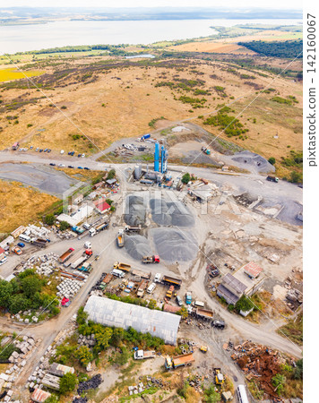 Granite quarry with heavy machinery and workers engaged in stone extraction and processing Granite quarry with heavy machinery and workers engaged in stone extraction and processing 142160067