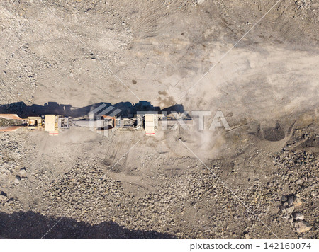Granite quarry work shows heavy machinery cutting and processing stone during daytime operations 142160074