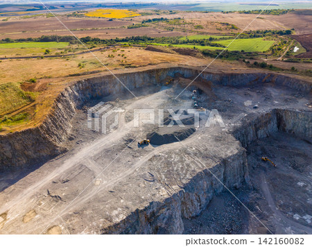 Granite quarry site in a rural area with heavy machinery working on stone extraction and processing Granite quarry site in a rural area with heavy machinery working on stone extraction and processing 142160082
