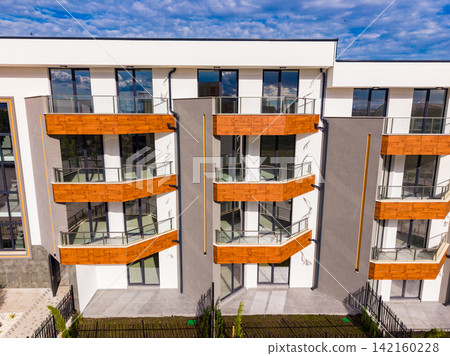New residential building with modern design in a developing area during daytime New residential building with modern design in a developing area during daytime 142160228