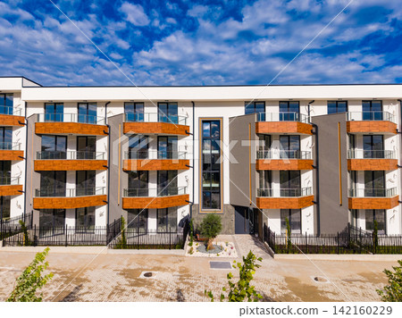 Modern apartment building with balconies in a sunny location Modern apartment building with balconies in a sunny location 142160229