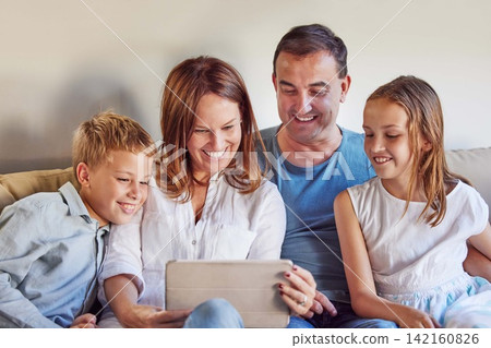 Movie, happy and family with tablet on sofa for online streaming, digital network and subscription. Father, mother and kids with technology at home for development, bonding and film on internet Movie, happy and family with tablet on sofa for online streaming, digital network and subscription. Father, mother and kids with technology at home for development, bonding and film on internet 142160826