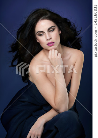 Fashion, beauty and woman on blue background with style for glamour, designer clothes and outfit. Aesthetic, attractive model and confident person with makeup, cosmetics and hairstyle in studio Fashion, beauty and woman on blue background with style for glamour, designer clothes and outfit. Aesthetic, attractive model and confident person with makeup, cosmetics and hairstyle in studio 142160833