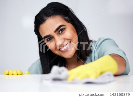 Indian woman, portrait or cleaner with cloth for table, kitchen counter or dirty furniture in home. Safety, maid or happy janitor washing messy surface with fabric, liquid soap or smile with gloves Indian woman, portrait or cleaner with cloth for table, kitchen counter or dirty furniture in home. Safety, maid or happy janitor washing messy surface with fabric, liquid soap or smile with gloves 142160879