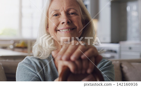 Smile, walking stick and portrait of senior woman on sofa in living room at retirement home. Happy, confident and elderly female person with a disability for hands on cane relaxing in lounge at house 142160916