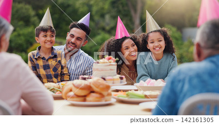 Parents, children and happy with birthday cake in garden with care, love and bonding with food at family home. Father, mother and kids with hat for party, event and embrace at table with celebration Parents, children and happy with birthday cake in garden with care, love and bonding with food at family home. Father, mother and kids with hat for party, event and embrace at table with celebration 142161305