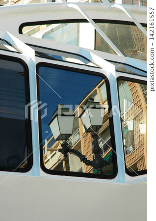 Urban reflection in tourist boat windows Urban reflection in tourist boat windows 142161557