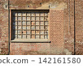 Bricked up window in an old industrial red brick wall 142161580