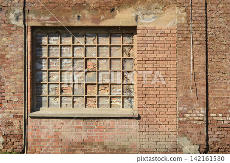 Bricked up window in an old industrial red brick wall 142161580