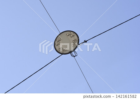 Catenary Suspended LED Street Light Against Blue Sky Catenary Suspended LED Street Light Against Blue Sky 142161582