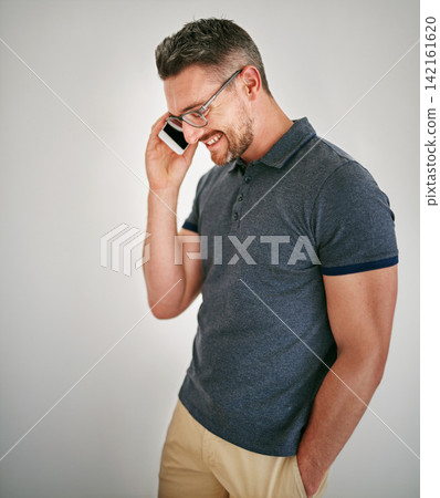 Phone call, smile and man with conversation, contact and communication on grey studio background. Person, model and guy with a smartphone and discussion with planning and speaking with network or app Phone call, smile and man with conversation, contact and communication on grey studio background. Person, model and guy with a smartphone and discussion with planning and speaking with network or app 142161620