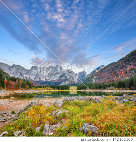 Fabulous view of Fusine lake with Mangart peak on background. Fabulous view of Fusine lake with Mangart peak on background. 142162100