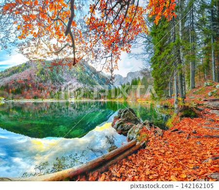 Stunning view of Fusine lake with Mangart peak on background. Stunning view of Fusine lake with Mangart peak on background. 142162105