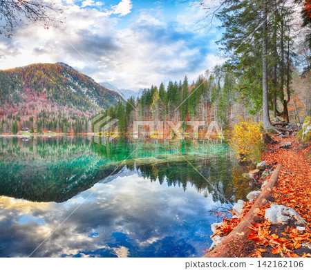 Fabulous view of Fusine lake with Mangart peak on background. Fabulous view of Fusine lake with Mangart peak on background. 142162106