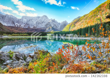 Breathtaking view of Fusine lake with Mangart peak on background. Breathtaking view of Fusine lake with Mangart peak on background. 142162108