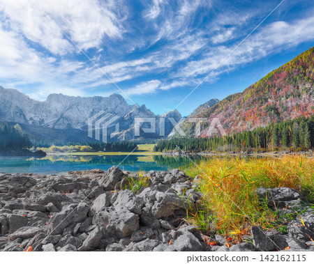 Breathtaking view of Fusine lake with Mangart peak on background. Breathtaking view of Fusine lake with Mangart peak on background. 142162115