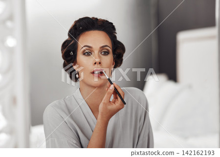 Woman, beauty brush and makeup for gala in bedroom, reflection and cosmetics application. Bride, foundation treatment and preparation for wedding at salon, wellness and skincare for celebration home Woman, beauty brush and makeup for gala in bedroom, reflection and cosmetics application. Bride, foundation treatment and preparation for wedding at salon, wellness and skincare for celebration home 142162193