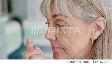 Contact lenses, finger and senior woman with eye care, healthcare and wellness in optical store. Optometry, health and female person in retirement in shop for glaucoma, vision and ophthalmology 142162252