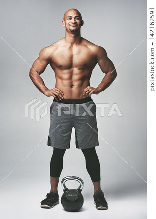 Black man, portrait and kettle bell in studio, shirtless and confidence for workout or training. Male person, athlete and weightlifting for muscle progress on gray background, smile and challenge Black man, portrait and kettle bell in studio, shirtless and confidence for workout or training. Male person, athlete and weightlifting for muscle progress on gray background, smile and challenge 142162591