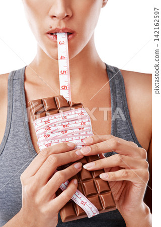 Chocolate, bite and woman in studio with measuring tape for unhealthy diet, sugar craving or junk food on white background. Eating, dessert and model for snack temptation, cocoa candy or weight gain Chocolate, bite and woman in studio with measuring tape for unhealthy diet, sugar craving or junk food on white background. Eating, dessert and model for snack temptation, cocoa candy or weight gain 142162597