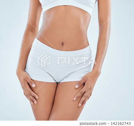 Woman, healthy stomach and underwear in studio, fitness and skincare on white background. Female person, abdomen and confident for body care or weight loss, wellness and lingerie for slim shape Woman, healthy stomach and underwear in studio, fitness and skincare on white background. Female person, abdomen and confident for body care or weight loss, wellness and lingerie for slim shape 142162743