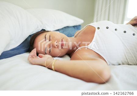 Woman, sleeping and relax in bed on morning, peace and dreaming on blanket and cozy on duvet. Female person, rest and calm in nap or fatigue and tired, bedroom and pillow for comfort and tranquil 142162766