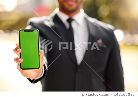 Hand, show and outdoor with phone, green screen and person in corporate, business and advertising. Mobile, display and technology of product placement, suit and bokeh in city, park and New York Hand, show and outdoor with phone, green screen and person in corporate, business and advertising. Mobile, display and technology of product placement, suit and bokeh in city, park and New York 142163053