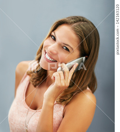 Face, phone call and happy woman talking in studio for story, gossip or news discussion isolated on a gray background. Mobile, smile or portrait of model in conversation, chat or listening to contact Face, phone call and happy woman talking in studio for story, gossip or news discussion isolated on a gray background. Mobile, smile or portrait of model in conversation, chat or listening to contact 142163120