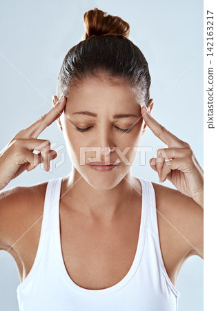 Frustrated woman, headache and stress with anxiety, depression or pain in burnout on a gray studio background. Tired or exhausted female person or young athlete with migraine, mental health or strain Frustrated woman, headache and stress with anxiety, depression or pain in burnout on a gray studio background. Tired or exhausted female person or young athlete with migraine, mental health or strain 142163217