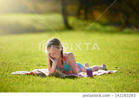 Girl, book or reading to relax, grass or imagine by story, freedom or vacation at summer camp. Tween, novel or fiction as thinking to wonder of idea, dream or fantasy by lying on ground in nature Girl, book or reading to relax, grass or imagine by story, freedom or vacation at summer camp. Tween, novel or fiction as thinking to wonder of idea, dream or fantasy by lying on ground in nature 142163263