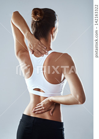 Back, fitness and stretching with sports woman in studio isolated on gray background for workout. Arms, exercise and hands with athlete at gym for training, performance or warm up preparation Back, fitness and stretching with sports woman in studio isolated on gray background for workout. Arms, exercise and hands with athlete at gym for training, performance or warm up preparation 142163322