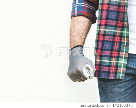 Attractive man, clenched fist and work clothes Attractive man, clenched fist and work clothes 142163373