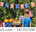 Cute dog, American Flag, two delicious hamburgers and pumpkins 142163396