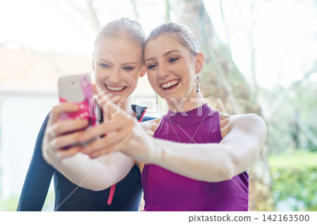 Ballet, people and smile, selfie outdoor after training and competition or theatre. Dancers, happy and friends take photo or bond with smartphone for excited memory, social media or internet post Ballet, people and smile, selfie outdoor after training and competition or theatre. Dancers, happy and friends take photo or bond with smartphone for excited memory, social media or internet post 142163500
