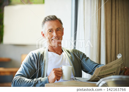 Mature, man and newspaper for reading in home, relax and information or articles in morning with coffee. News, breakfast table and rest and calm for entertainment pages, current events in apartment Mature, man and newspaper for reading in home, relax and information or articles in morning with coffee. News, breakfast table and rest and calm for entertainment pages, current events in apartment 142163766