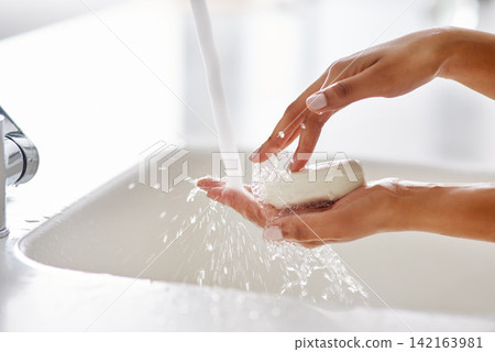 Water, soap and hands in bathroom for hygiene, cleaning and protection from germs at home. Covid awareness, woman and washing in washroom for skincare, bacteria and cleanliness in house for safety 142163981