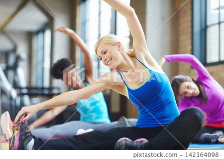 Yoga, happy and women stretching on floor in gym for wellness, fitness and exercise with diversity. Girl, people and coach with athlete class training for energy, balance or workout with team Yoga, happy and women stretching on floor in gym for wellness, fitness and exercise with diversity. Girl, people and coach with athlete class training for energy, balance or workout with team 142164098