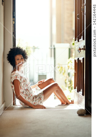 Black woman, happy and portrait sitting in doorway as cheerful, relax and peace for weekend in home. Female person, funny and apartment for calm, morning and playful with smile on floor for leisure Black woman, happy and portrait sitting in doorway as cheerful, relax and peace for weekend in home. Female person, funny and apartment for calm, morning and playful with smile on floor for leisure 142164448