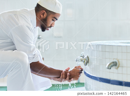 Washing hands, muslim and man with cleaning tradition in bathroom for religion and prayer routine. Islamic, spiritual and eid with culture and wellness in mosque for ramadan and respoect for faith Washing hands, muslim and man with cleaning tradition in bathroom for religion and prayer routine. Islamic, spiritual and eid with culture and wellness in mosque for ramadan and respoect for faith 142164465