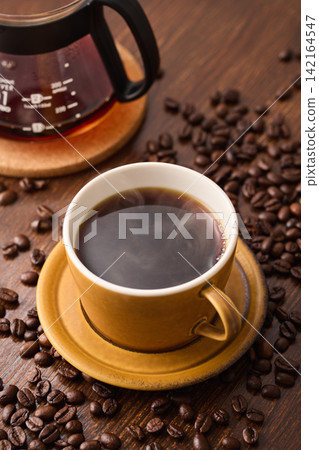 coffee poured into a cup coffee poured into a cup 142164547