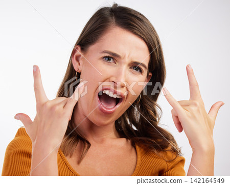 Excited, rocker hands and portrait of woman in studio with energy, confidence and fun on white background. Punk, emoji and face of model with shouting, freedom and sign music, band or concern support Excited, rocker hands and portrait of woman in studio with energy, confidence and fun on white background. Punk, emoji and face of model with shouting, freedom and sign music, band or concern support 142164549