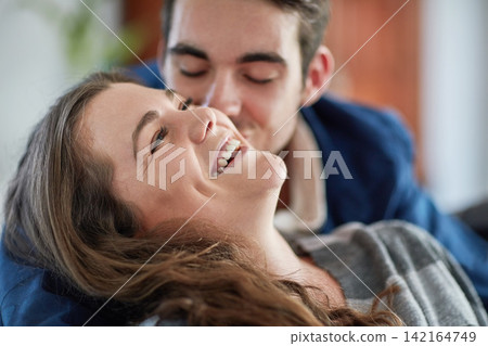 Face, love and smile with couple in living room of home together for bonding, romance or trust. Funny, laughing or relax with happy man and woman in apartment for comedy, humor or weekend fun Face, love and smile with couple in living room of home together for bonding, romance or trust. Funny, laughing or relax with happy man and woman in apartment for comedy, humor or weekend fun 142164749