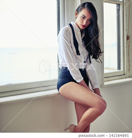 Undressing, woman and thinking with classic, dress shirt and formal fashion in the morning in cabaret studio. Idea, home and window with dance costume and elegant style with high heels and shoes Undressing, woman and thinking with classic, dress shirt and formal fashion in the morning in cabaret studio. Idea, home and window with dance costume and elegant style with high heels and shoes 142164891
